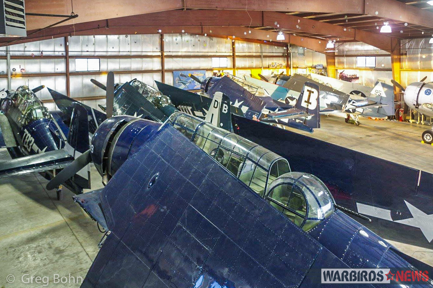 Six of the seven TBM's to attend the 2017 Gathering protected from the stormy weather, aircraft carrier storage deck style, within the City of Peru's hangar. (Photo by Greg Bohn)
