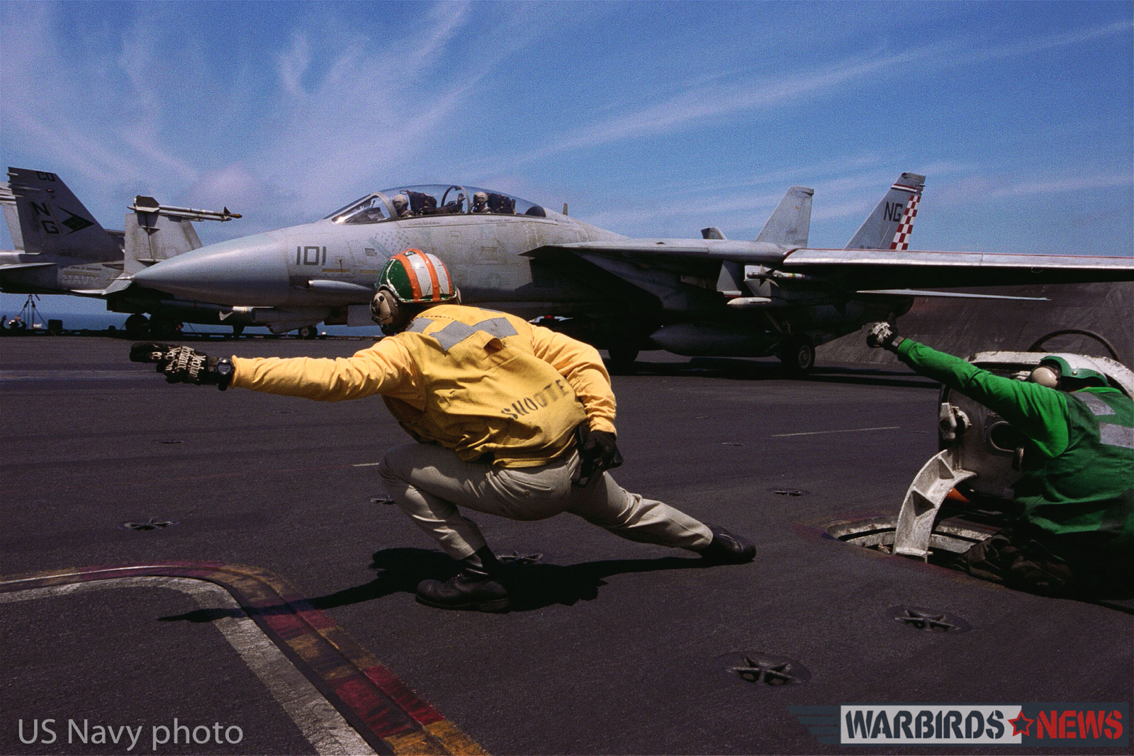 At sea aboard USS John C. Stennis (CVN 74) Apr. 12, 2002 -- Lt. David Sanderson from San Diego, CA, gives the launch signal to the pilot of an F-14 "Tomcat" assigned to the "Checkmates" of Fighter Squadron Two One One (VF-211). John C. Stennis and Carrier Air Wing Nine (CVW-9) are conducting combat missions in support of Operation Enduring Freedom. U.S. Navy photo by Photographer's Mate 3rd Class Jayme T. Pastoric. (RELEASED)