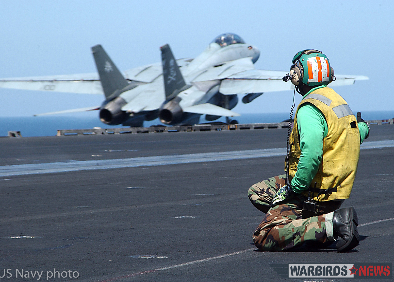 At sea aboard USS George Washington (CVN 73) Sep. 8, 2002 -- Aviation Boatswain's Mate 2nd Class Michael Keys from Orlando, Fla., watches an F-14 "Tomcat," assigned to the "Jolly Rogers" of Fighter Squadron One Zero Three (VF-103) gain altitude after launch. Washington is homeported in Norfolk, Va., and is on a six-month deployment conducting combat missions in support of Operation Southern Watch. U.S. Navy photo by Photographer's Mate Airman Jessica Davis. (RELEASED)