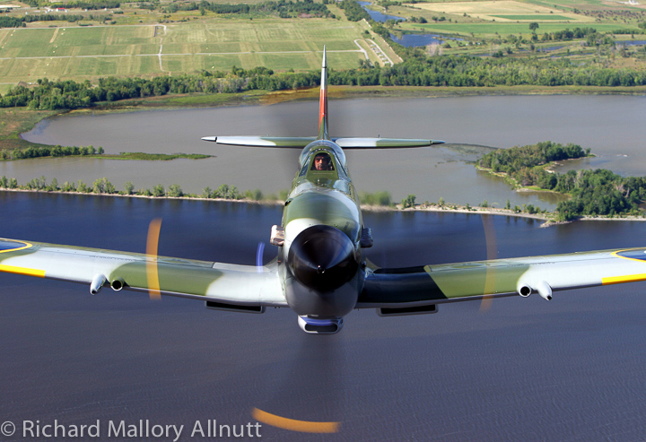 Mike Potter flying Vintage Wings of Canada's Supermarine Spitfire Mk.XVI over the Ottawa River near Gatineau, Quebec. 