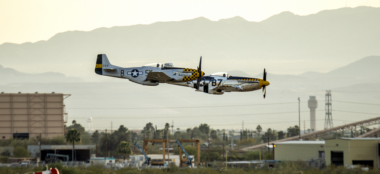 Two P-51D Mustangs that were among the vintage fighter aircraft participating in the Heritage Flight Training Course at Davis-Monthan AFB, Tucson, Ariz., Mar 3, 2016, make a low pass in formation over the airfield . (U.S. Air Force photo by J.M. Eddins Jr.)