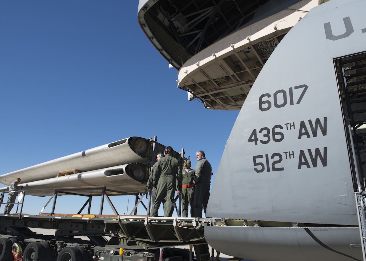 Loadmasters from the 709th Airlift Squadron prepare to load the wings of the Fairchild C-119B Flying Boxcar #48-0352 “Am Can Co Special” into a C-5M Super Galaxy Dec. 19, 2016, at Edwards Air Force Base, Calif. The wings were the only portions of the C-119 to be loaded through the C-5M’s forward ramp. (U.S. Air Force photo by Senior Airman Zachary Cacicia)
