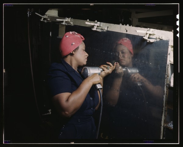 One of the many thousand "Rosie the Riveters" at work  in a WWII aircraft factory.