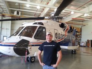 Happy Patrick Mihalek and the 'copter that will greatly simplify the retrieval of the Mitchell. (Image Credit: Sandbar Mitchell Restoration)