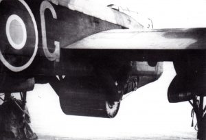 Upkeep bomb mounted to Lancaster. Note the chain drive mounted to the right of the bomb to impart the required 500RPM spin.