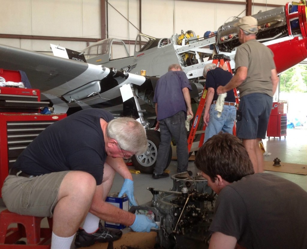 Open nose surgery. Members of CAF Dixie Wing pitch in to make repairs to their P-51-D "Red Nose" (Image Credit: CAF Dixie Wing)