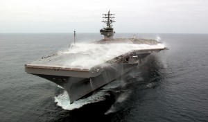 USS Ronald Reagan (CVN 76) captured during a test of its flight deck firefighting/wash-down system, mandated on all carriers in the wake of the Forrestal fire (Image Source: US Navy)