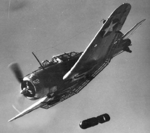 Iconic shot of a SBD Dauntless, dive brakes extended and dropping a bomb. (Image Credit: US Navy)
