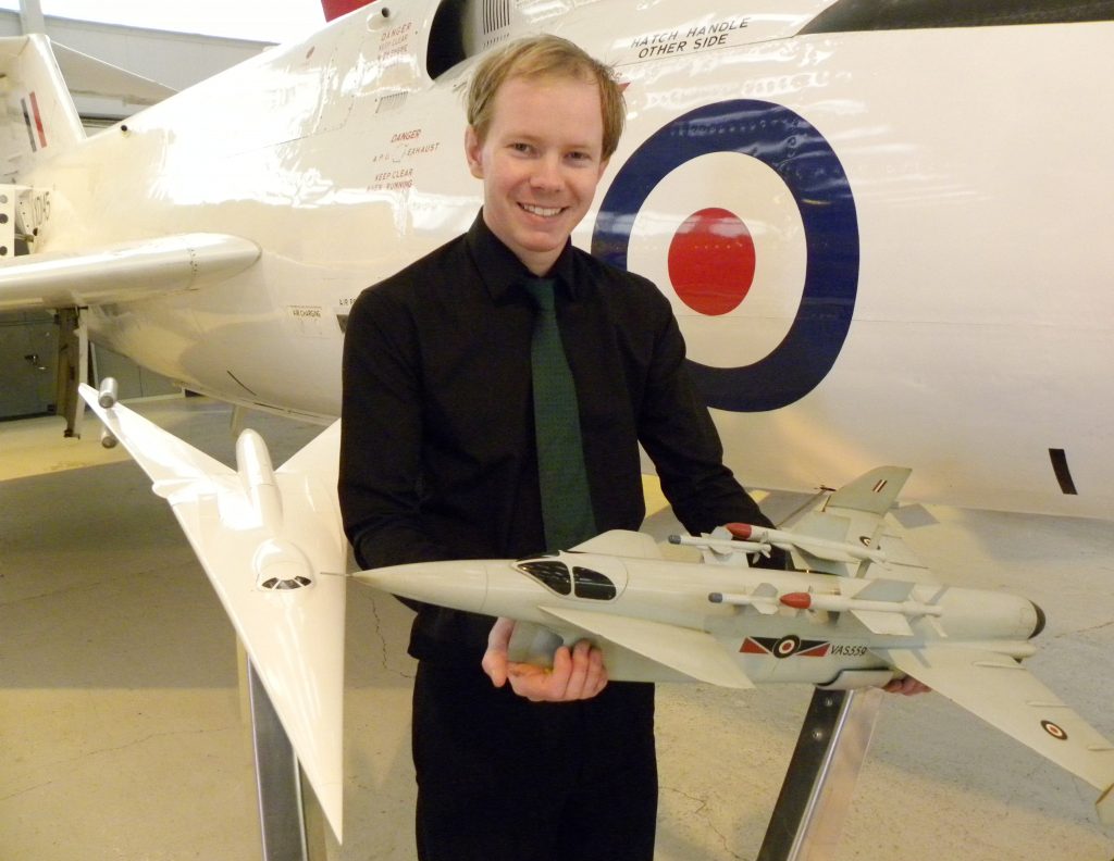 RAFM Curator Nick Sturgess with two concept models, holding the Vickers Type 559. (Image Credit: RAF Museum)