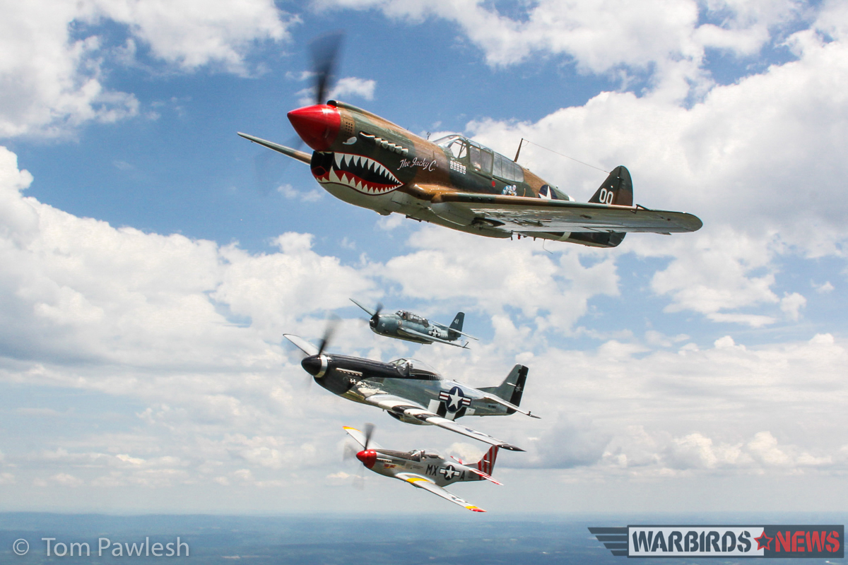 Another great air-to-air with the P-51s, P-40 and TBM. (Photo by Tom Pawlesh)