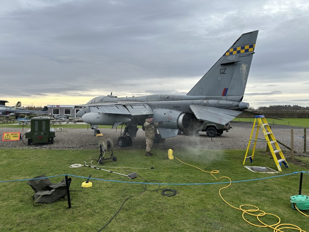 One of the museum's team washing Jaguar T.2 XX829 is also set to receive a repaint in 2024. [Photo by Howard Heeley, Down To Earth Promotions]