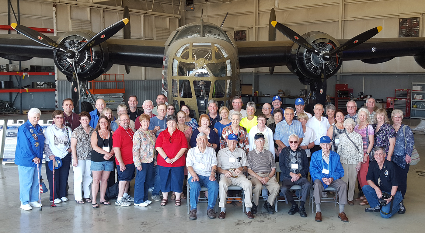 5 World War II veterans (seated) of the 380th Bombardment Group (Heavy) pose with family members in front of the Commemorative Air Force (CAF) Consolidated B-24 Liberator “Diamond Lil” on Friday, Oct 16th.  Over 50 members of the 380th Bomb Group Association toured the historic bomber at the CAF National Airbase at Dallas Executive Airport in Dallas, Texas.  (Photo Credit: Konley Kelley)