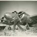 8 Amelia Earhart walking in front of her Lockheed Electra 10E courtesy Purdue University Libraries