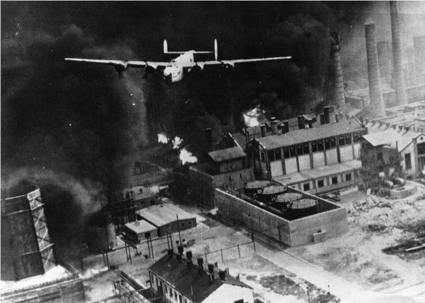 Consolidated B-24D-55-CO Liberator 42-40402, “The Sandman,” clears the triple stacks at the Astra Romana Refinery, Ploesti, Romania, 1 August 1943.