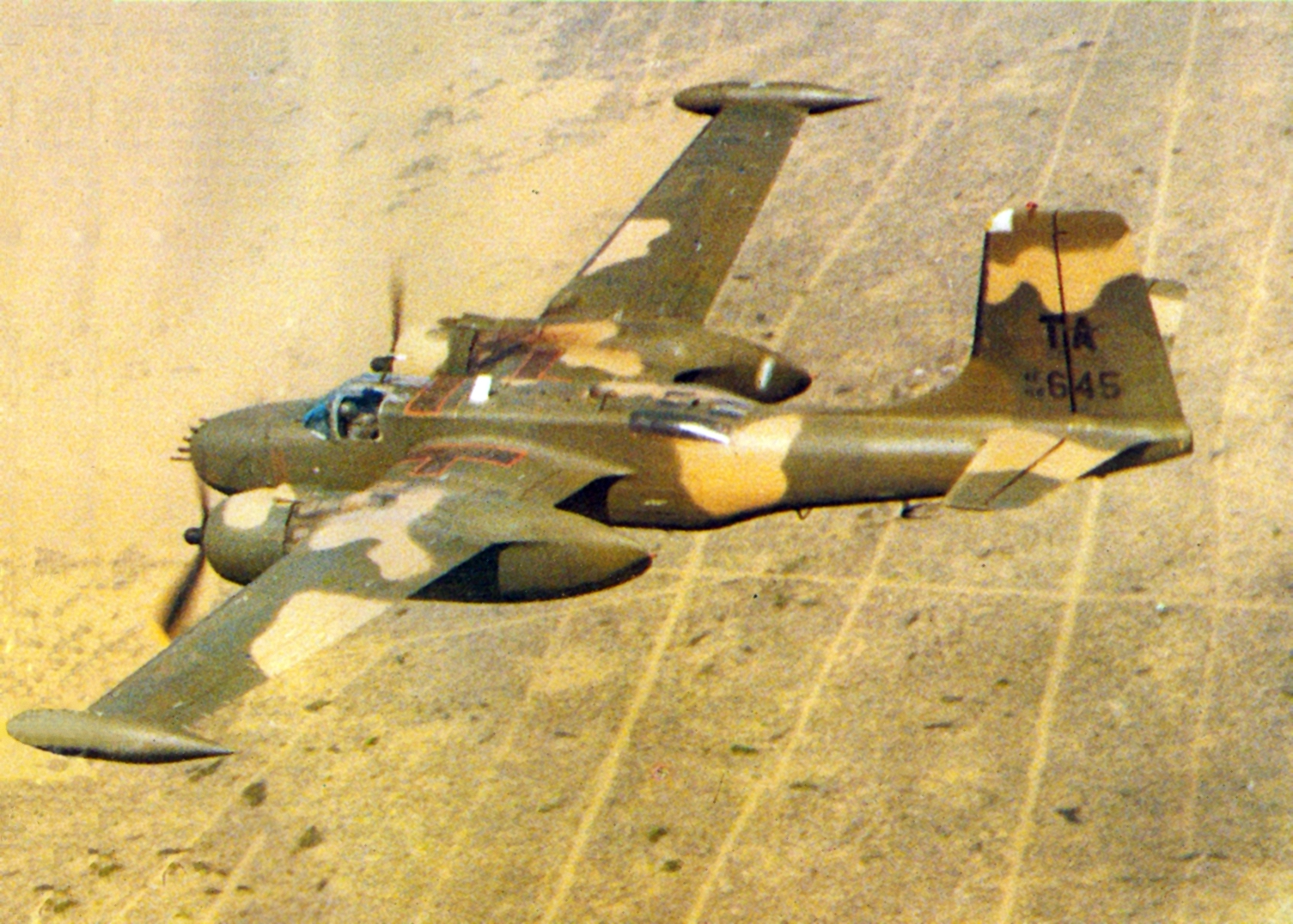 An A-26 Invader of the 609th Special Operations Squadron flying near Nakhon Phanom Royal Thai Air Base in 1969. ( Image via Wikipedia)