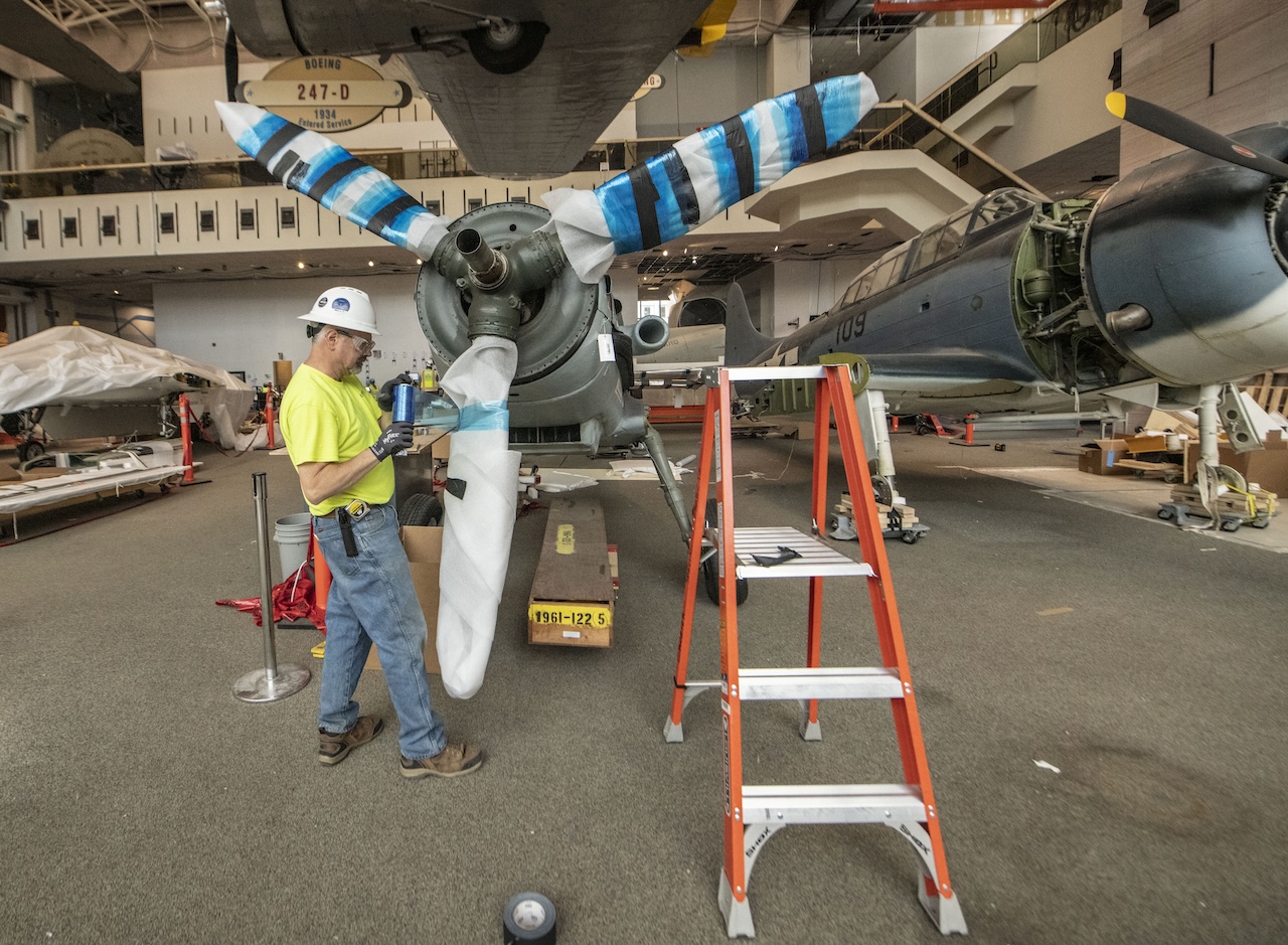 A contractor wraps a propeller on the Messerschmitt Bf 109 G 6 R3 in the closed America by Air gallery June 24 2019. Smithsonian photo by Jim Preston