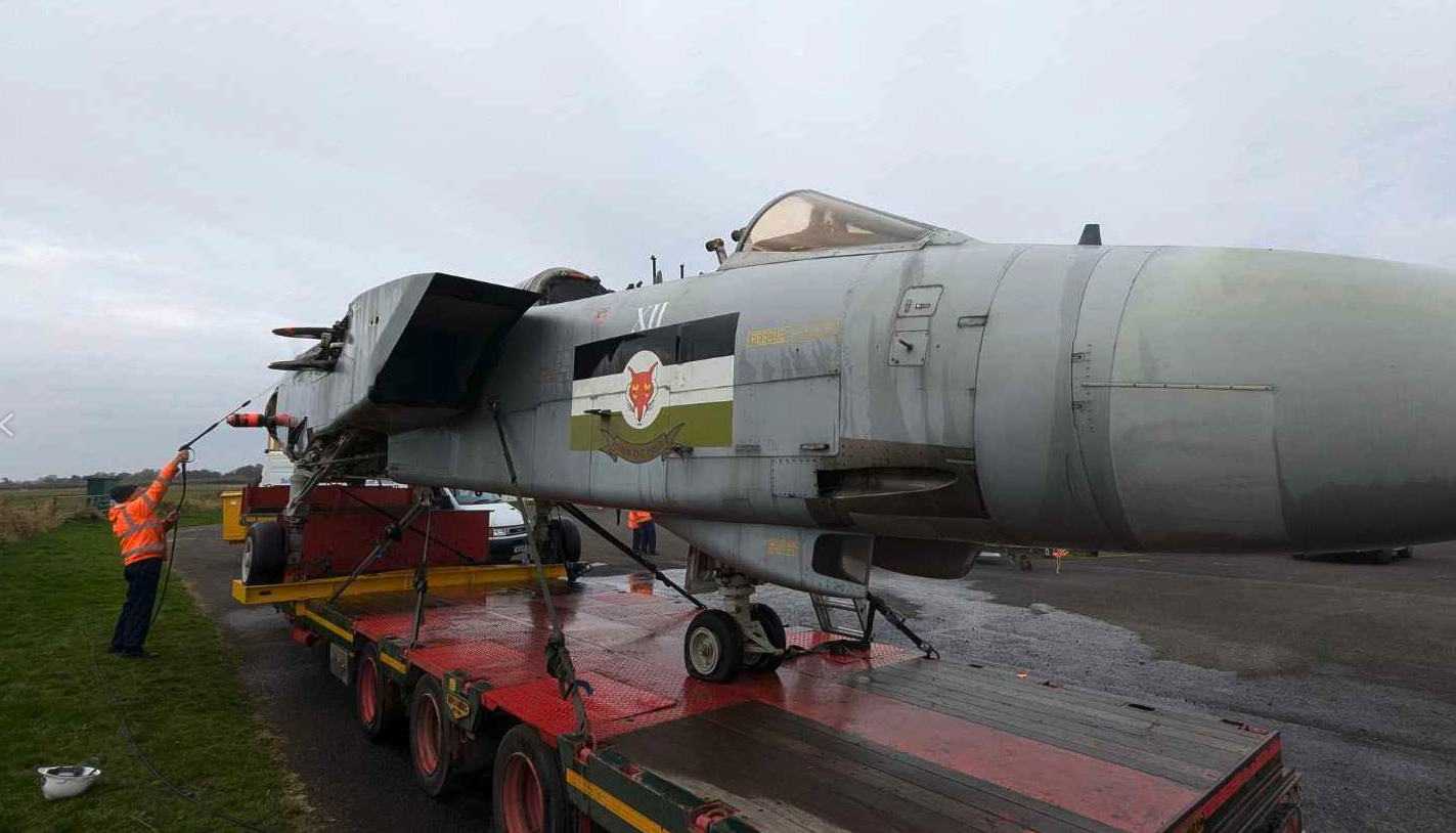 A volunteer washes the fuselage of Tornado ZA475