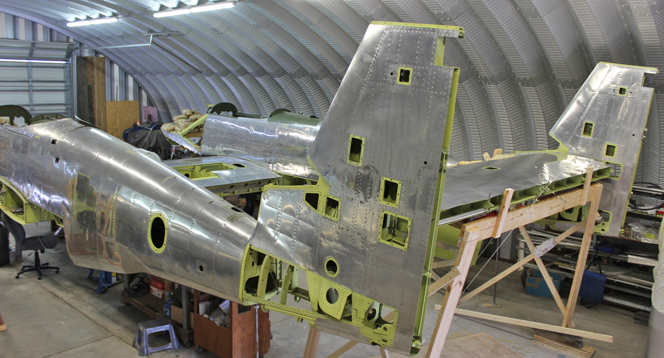 Offering up the rear fuselage/tail section to the main fuselages for final alignment and fitting. (photo via Tom Reilly)