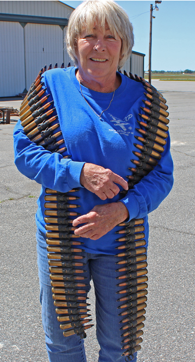 The armor lady with one of the freshly-assembled dummy ammunition belts for the XP-82. (photo via Tom Reilly)