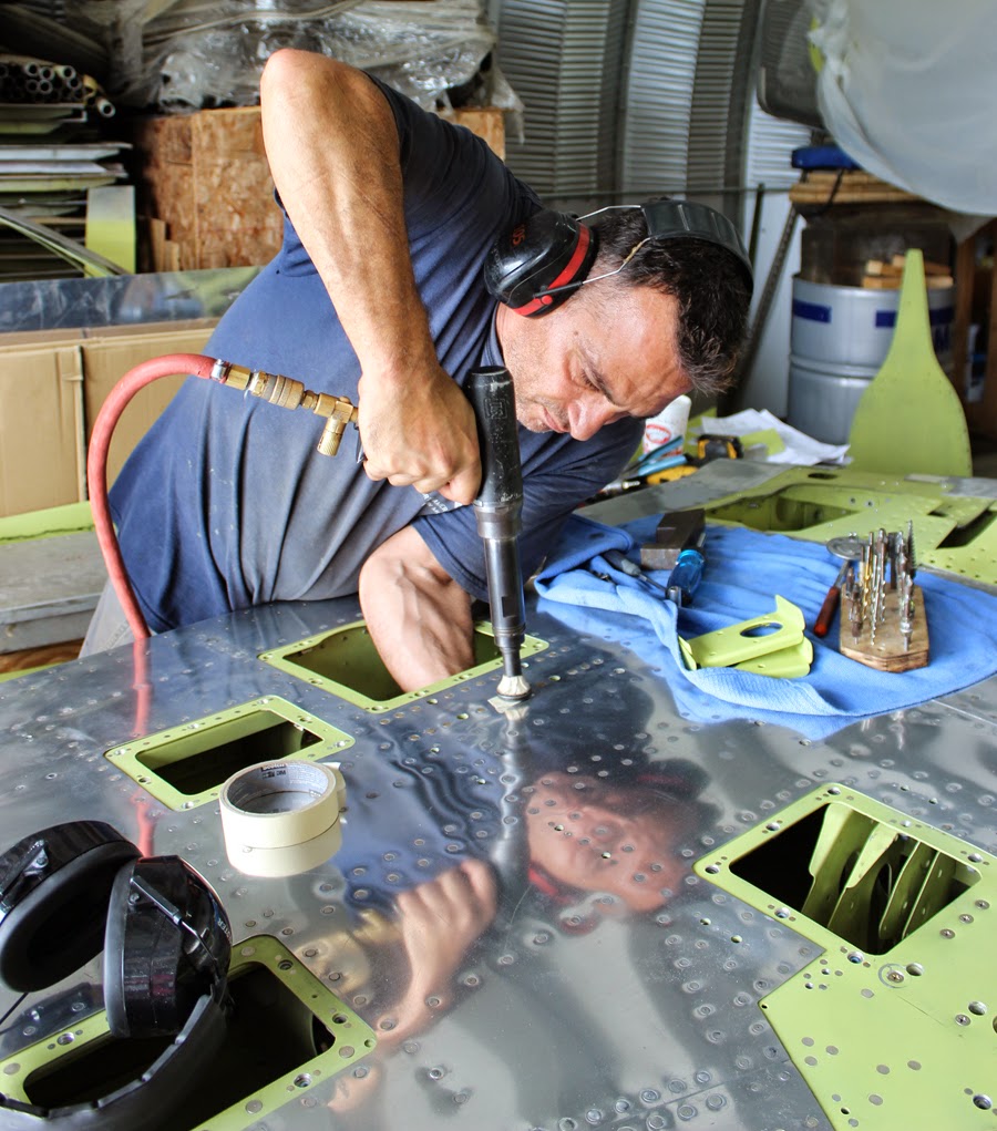 Ayman working on one of the two vertical stabilizers. (photo via Tom Reilly) 