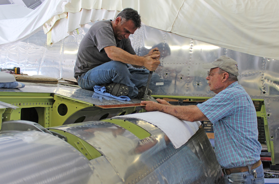 Tom Reilly (r) with Ayman installing the phenolic rub-strip for the flap. (photo via Tom Reilly)