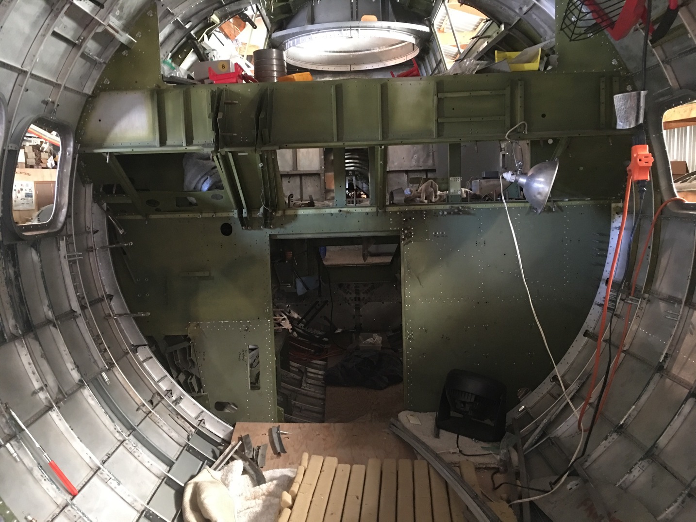 An interior view of Desert Rat's nose section looking back towards the cockpit. The small lower bulkhead opening is the entry point for the nose. It is a tight squeeze at the best of times, but imagine getting through that hole in a hurry while wearing a bulky fleece-lined flight suit. It's no surprise that crew members had a near impossible task exiting this area during an emergency! (photo via Vintage Aviation Museum) 