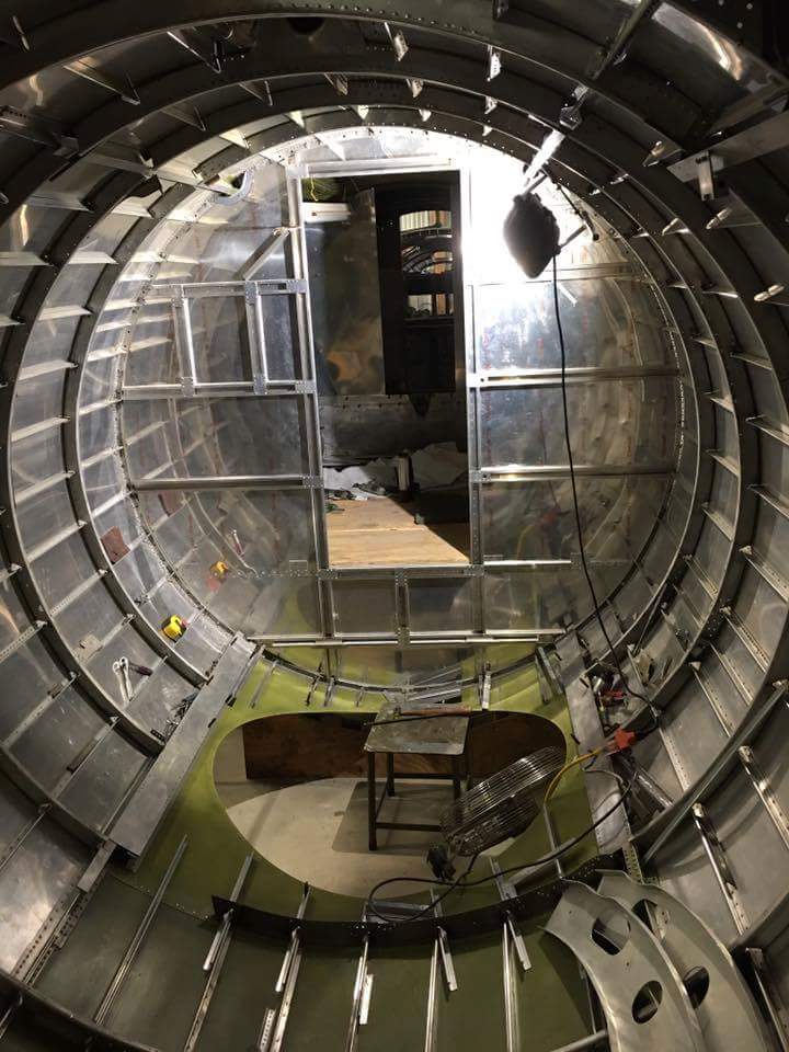 Desert Rat's fuselage interior. The hole in the floor will one day hold the ball turret, and the radio room bulkhead is just beyond. (photo via Vintage Aviation Museum) 