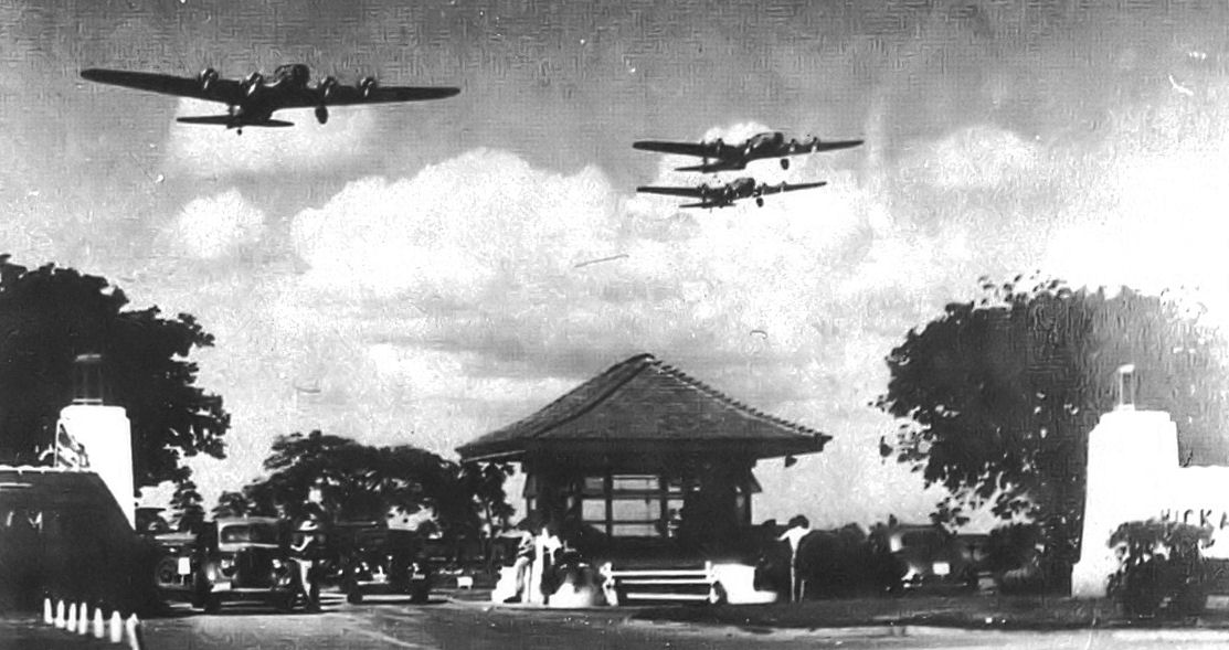 Boeing B-17D Fortresses of the 5th Bombardment Group overfly the main gate at Hickam Field, Hawaii Territory during the summer of 1941. 21 B-17C/Ds had been flown out to Hawaii during May to reinforce the defenses of the islands. (Photo via Wikipedia)