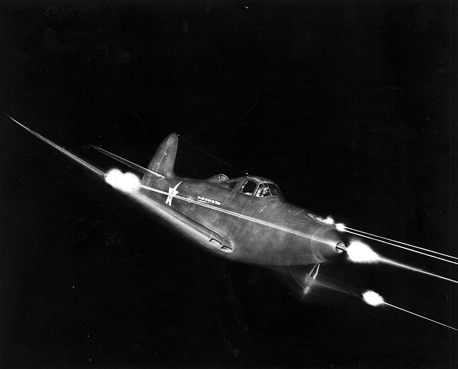 Bell P 39 Airacobra firing all weapons at night
