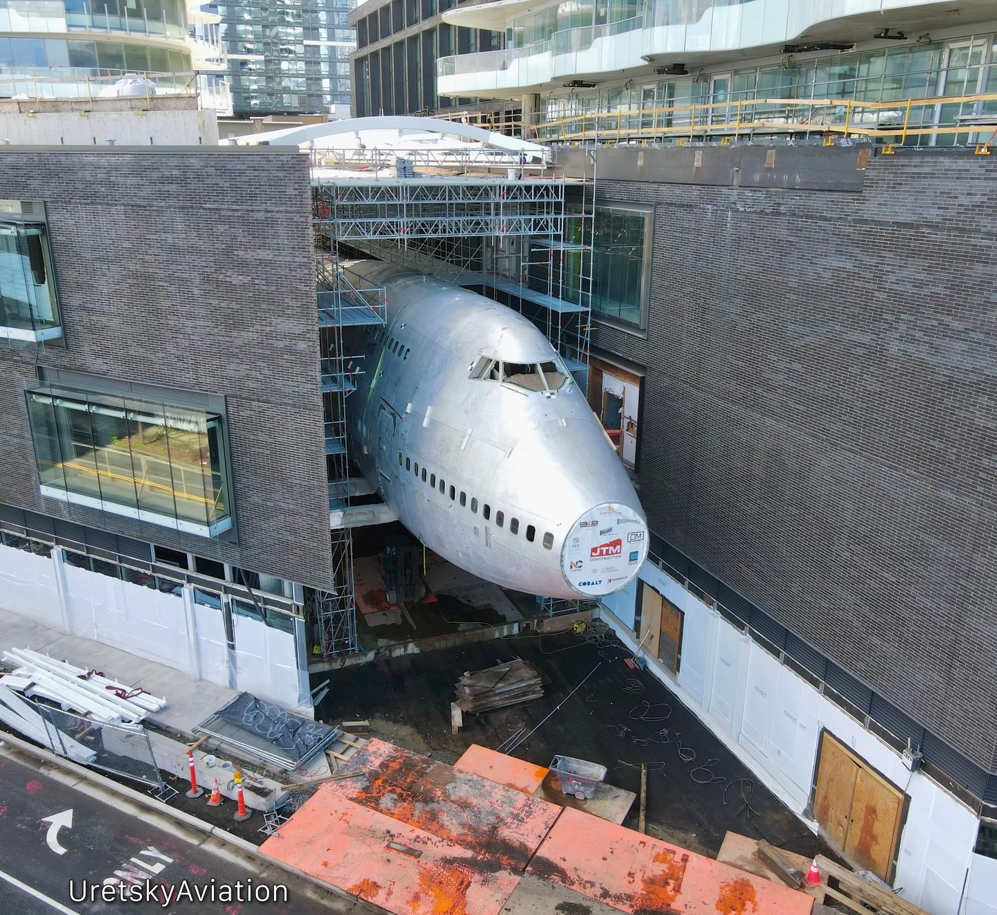 Boeing 747 Fuselage Suspended Between Seattle Towers in Striking
