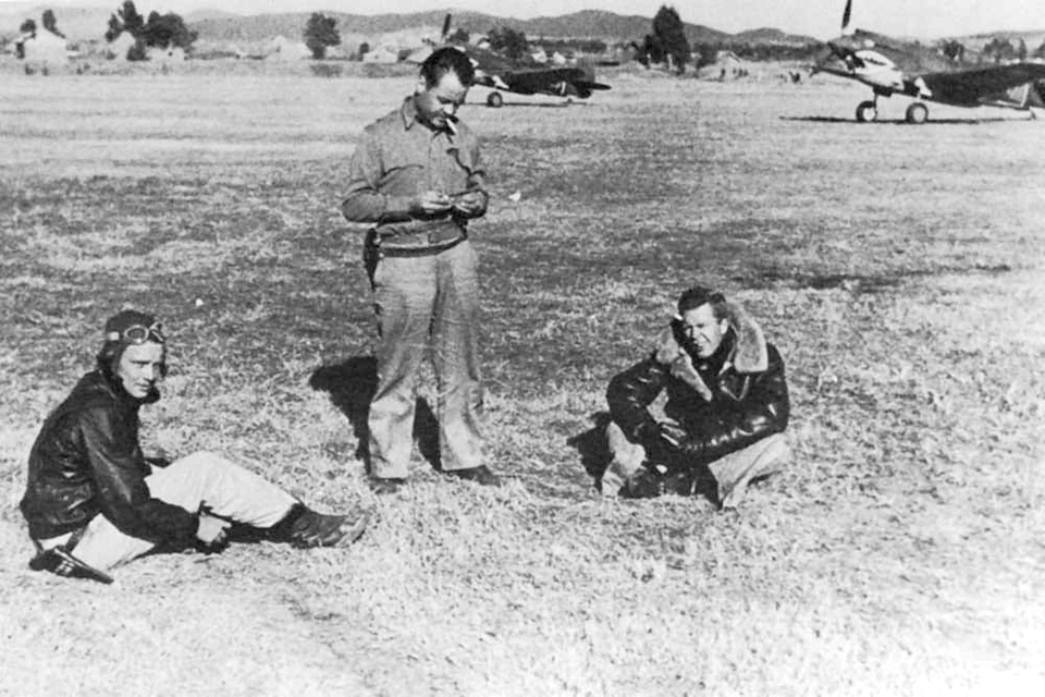 Boyington center takes a smoke break with squadron mates John Farrell left and John Croft. Since arriving at the AVG base at Kunming China Boyington was frustrated by a lack of action
