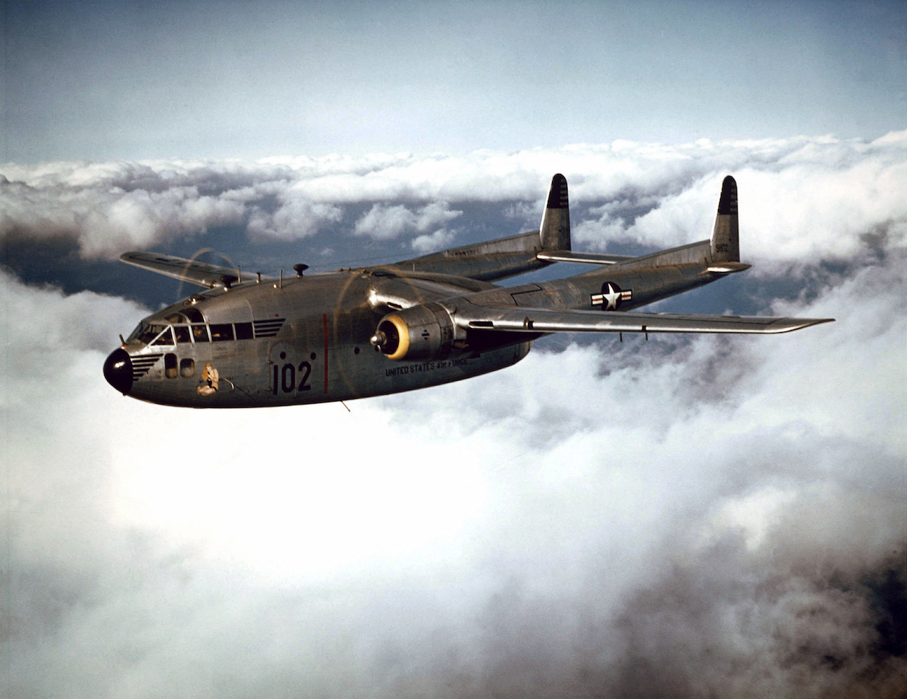 KOREAN WAR: AIRCRAFT C-119 COMBAT CARGO, KOREA - The 314th Troop Carrier Group C-119 Flying Boxcars do not start out for the "mountain" unless weather reports are good. They must be able to see the tiny drop zone on the peak before they can drop. But weather is so unpredictable in the high mountains, that often when the planes arrive, the entire area is "socked in" with heavy clouds. In the radio contact with the "men on the mountains," the pilots circle hoping for a break in the clouds, or sometimes, to dive under the clouds and drop on the lower slopes. On several occasions, the planes have had to return to Japan as many as three times without dropping. But 314th Troop Carrier Group pilots are presistant, and eventually win through to drop successfully. 1952