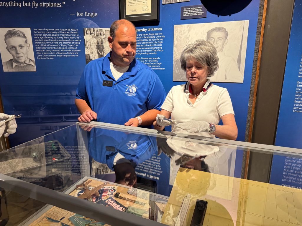 Chris Henry on Storytelling, Preservation, and the Future of the EAA Aviation Museum 15 Chris Henry Hope Stropes and Jeanie Engle placing artifacts into the Engle Exhibit of the museum.