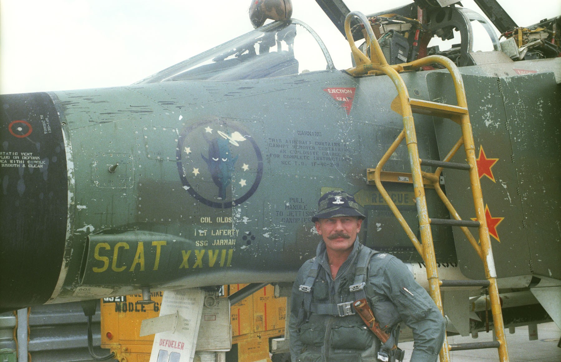 Col. Robin Olds poses with his F-4 Phantom II "Scat XXVII" at Ubon Royal Thai Air Force Base, Thailand. Olds had named his P-38s and P-51s in WWII "Scat" and carried this tradition into Vietnam. (U.S. Air Force Photo)