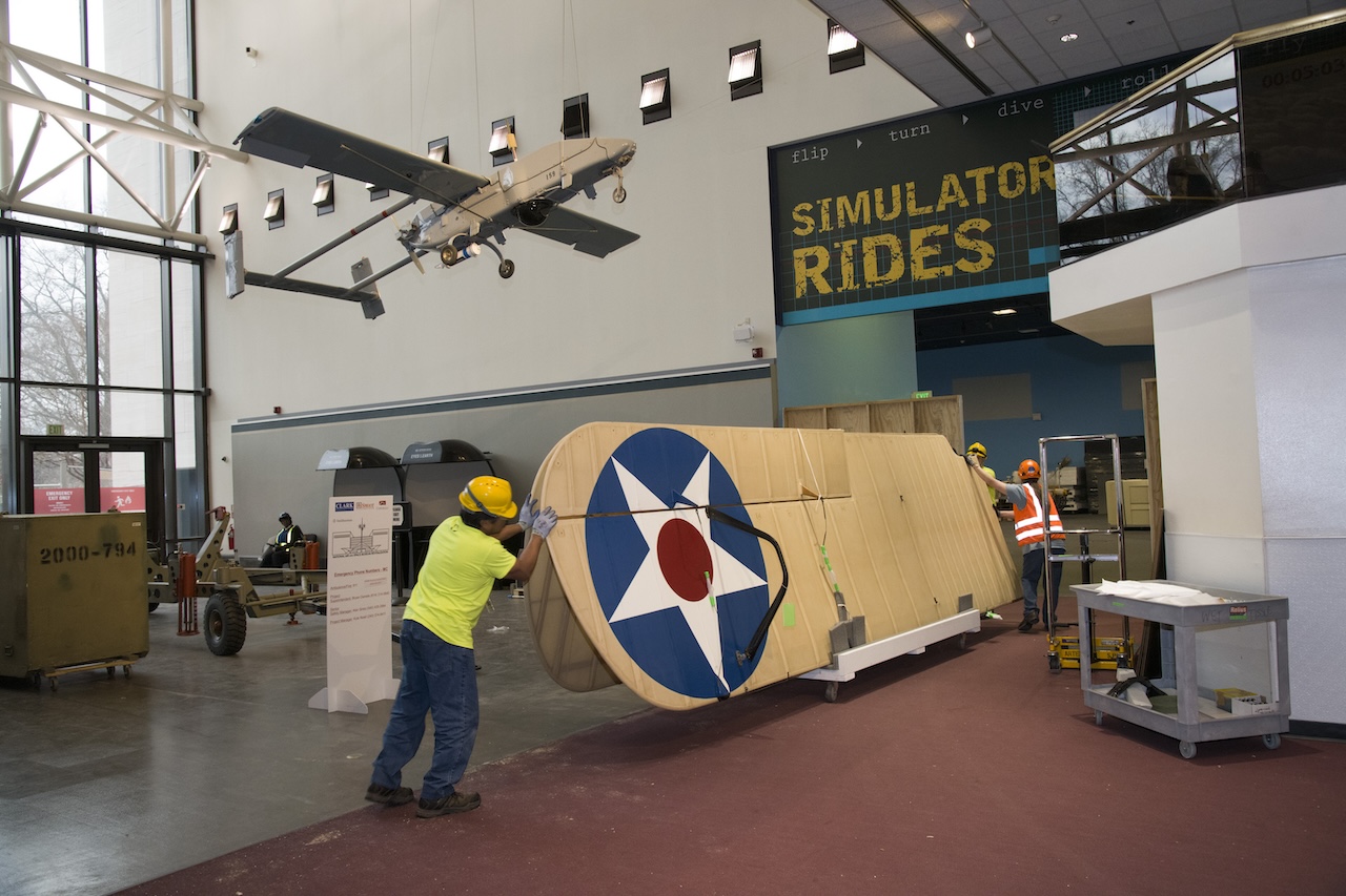 Contractors and staff move the wings of the De Havilland DH 4 into temporary storage at the National Air and Space Museum in Washington DC February 15 2019 . Smithsonian Photo by Mark Avino