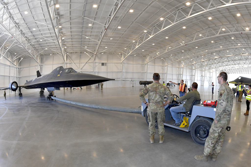 Crews relocate an SR 71 Blackbird static display inside the Hill Aerospace Museum
