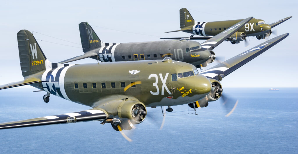 The impressive sight of three D-Day-marked C-47s in formation, comprising the Commemorative Air Force's That's All Brother, the Tunison Foundation's Placid Lassie and Airborne - Rendezvous with Destiny bringing up the rear.