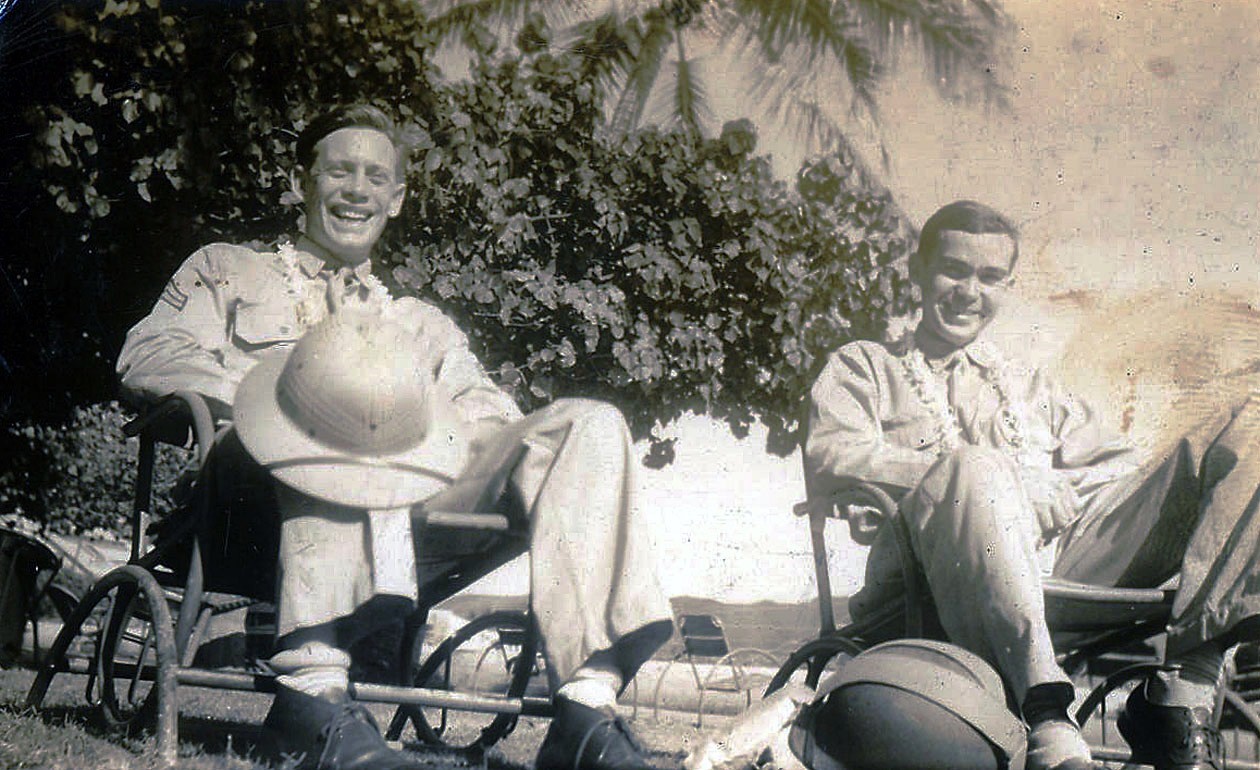 The author's dad, Herb Gilmore, with his buddy, Bill Hoagland, with pith helmets and wearing leis in Honolulu.