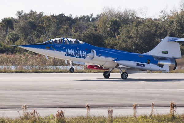 An F-104 Starfighter jet lands at Kennedy Space Center in Cape Canaveral on Tuesday after completing the maiden flight of a device known as Dust at Altitude Recovery Technology, or DART, which is being used to sample African dust in Florida’s atmosphere for potential pathogens of humans, plants and animals. The DART is the red, cylindrical device shown attached to the jet. UF/IFAS photo by Tyler L. Jones.