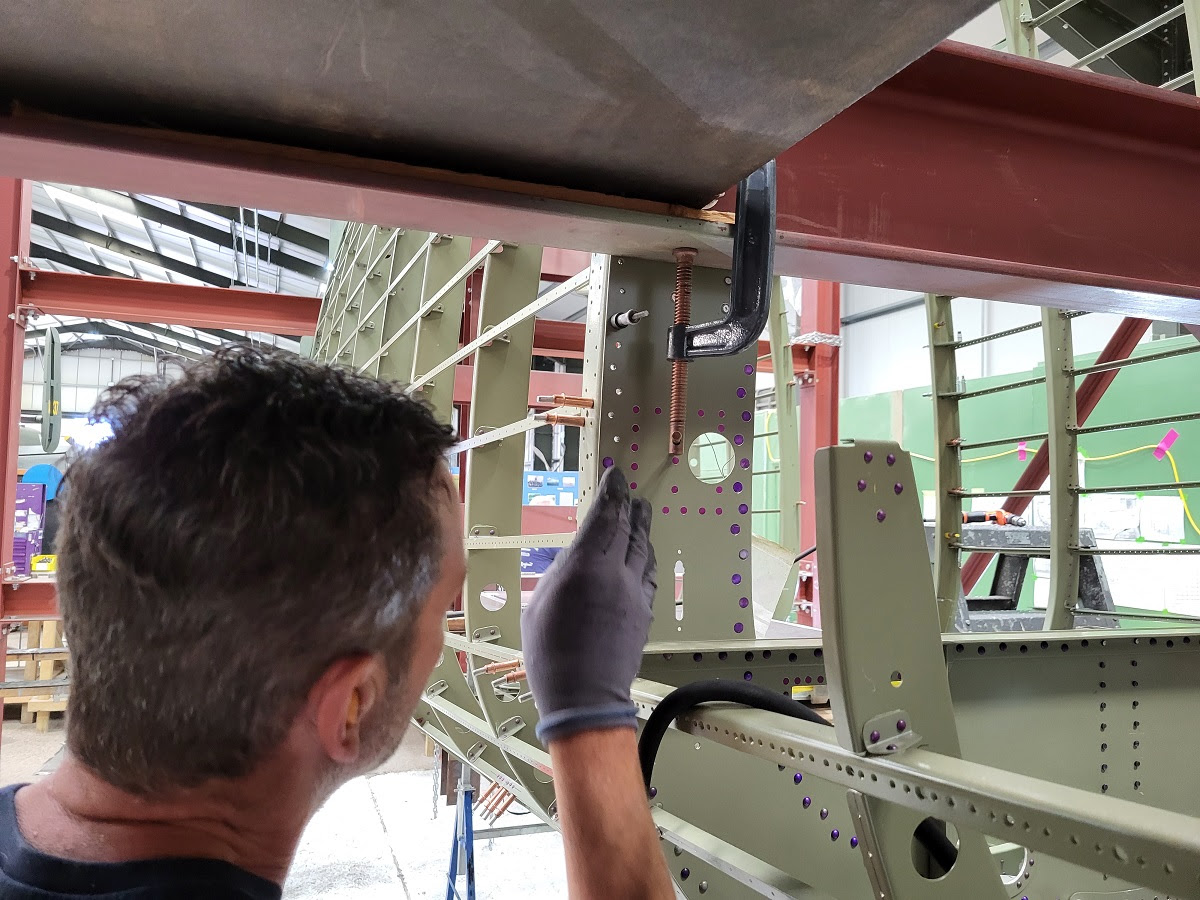 Dave fitting the countersunk rivets to the tail plane former area on the rear fuselage of NX611