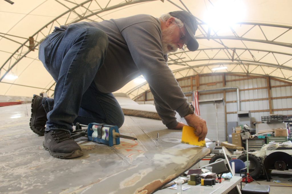 Wings of Freedom Aviation Museum Volunteers Near Completion of an F-8 Crusader Restoration 11 Drew Mansueto fills a hole on the wing of the F8