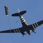 Event Exit exit.. Paratroopers exit a Douglas DC 3 C 47 Dakota Skytrain for a commorative jump over the D day invasion landing zones in Normandy France