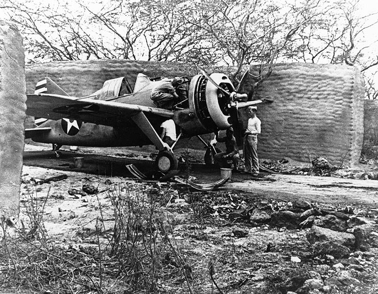 A Brewster F2A Buffalo (probably from Marine Corps Fighter Squadron VMF-221) undergoing maintenance in one of the early sandbag and stucco revetments at MCAS Ewa in April 1942.
