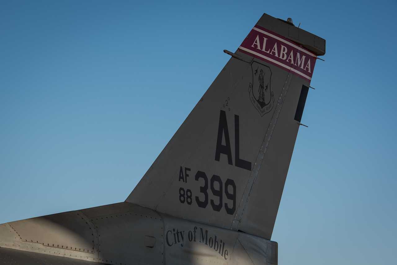 An F-16 from the Alabama Air National Guard arrives at the 407th Air Expeditionary Group where it is assigned to the 134th Expeditionary Fighter Squadron in support of Operation Inherent Resolve Dec. 10, 2016. The red tail flash of the jet brings the Tuskegee Airmen’s legacy back the 332nd Air Expeditionary Wing, to which the 134th EFS is currently assigned. (U.S. Air Force photo/Master Sgt. Benjamin Wilson)(Released)