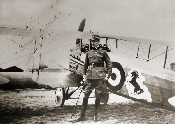 Count Francesco Baracca, standing by his SPAD XIII fighter with the prancing horse logo that later became the emblem of Ferrari.