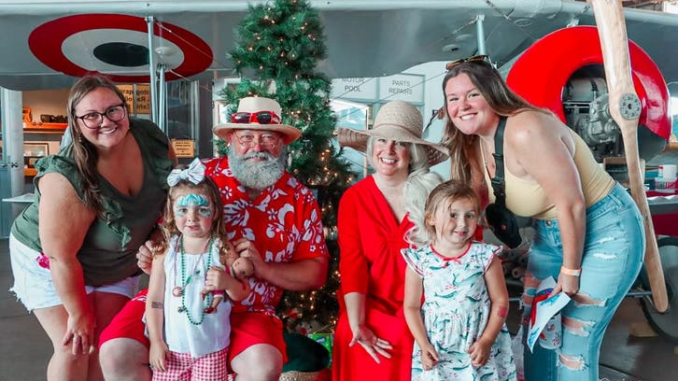 Family with Mr. Mrs. Claus at Christmas in July 2023 1