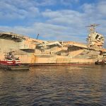 Former USS John F. Kennedy CV 67 aircraft carrier being towed out of the Naval Inactive Ship Maintenance Facility NISMF in Philadelphia