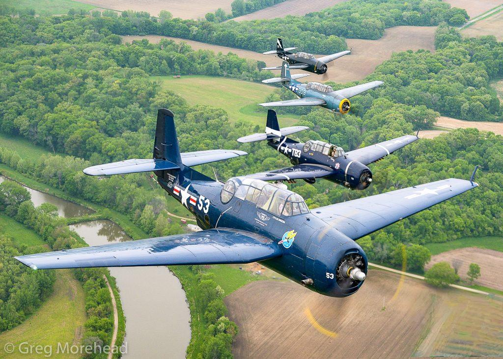 All 3 CAF TBM Avengers at the Gathering of Avengers, Peru, Illinois 16 Four Avengers in close formation during the TBM Gathering in Peru Illinois in 2018. Photo by Greg Morehead