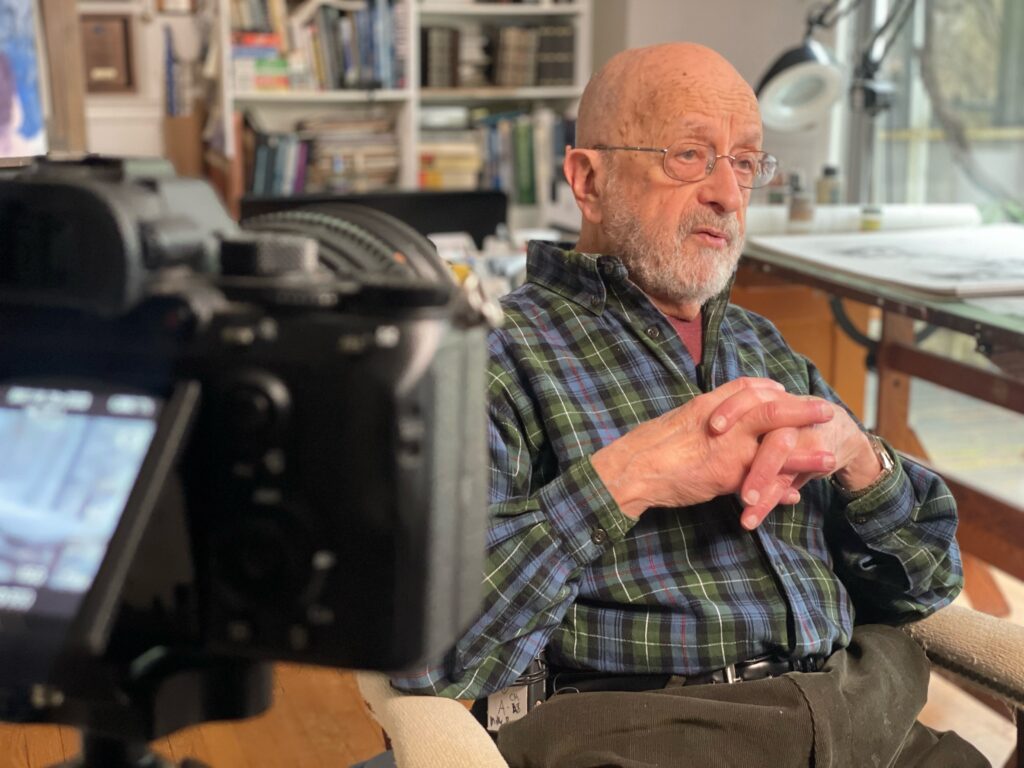 "Gil Cohen Interview" - Gil Cohen, renown Aviation Artist, pictured as he is interviewed in his studio.