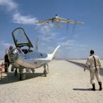 NASA research pilot Bill Dana takes a moment to watch NASA's NB-52B cruise overhead after a research flight in the HL-10.